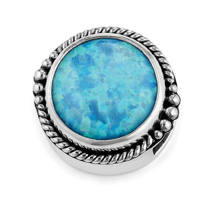 Silver jewelry piece featuring a vibrant round blue opal gemstone with iridescent turquoise and teal hues, bordered by a twisted rope design and delicate silver bead accents