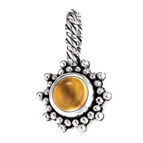 Silver pendant featuring a smooth amber-colored cabochon stone surrounded by a textured granulated sterling silver border and a braided bail