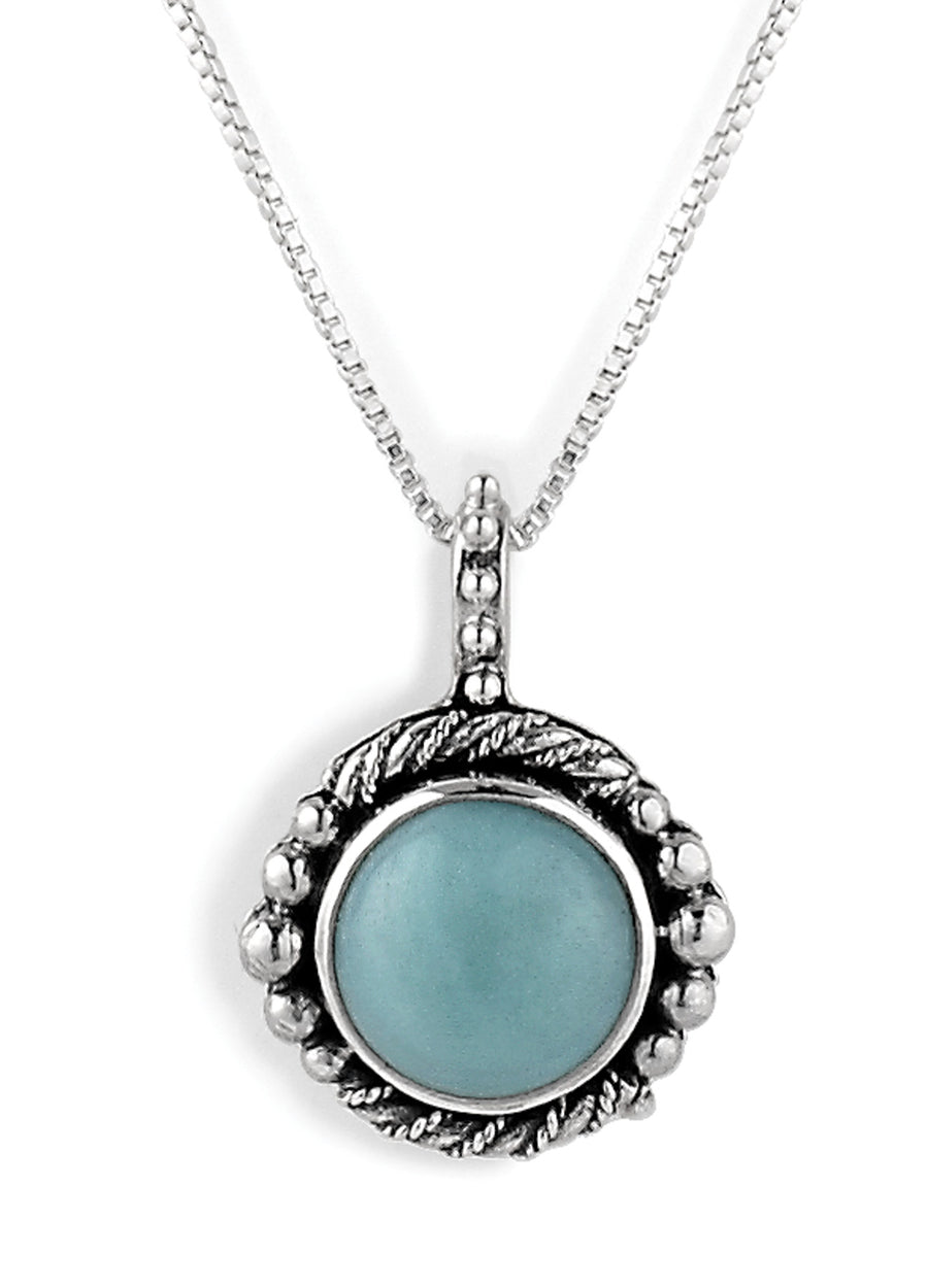 Sterling silver pendant necklace with a round light blue cabochon gemstone in an ornate setting featuring twisted rope and beaded accents on a box chain